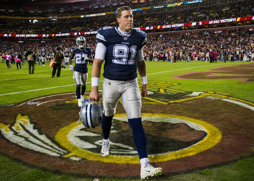 Dallas Cowboys long snapper L.P. LaDouceur (91) makes a face as he leaves the stadium after...