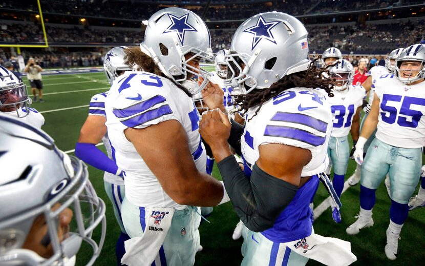 FILE - Cowboys middle linebacker Jaylon Smith (54) smashes helmets with center Joe Looney...