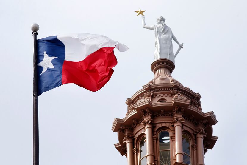 The Texas flag flies over the Texas Capitol in Austin, Texas, May 22, 2019.