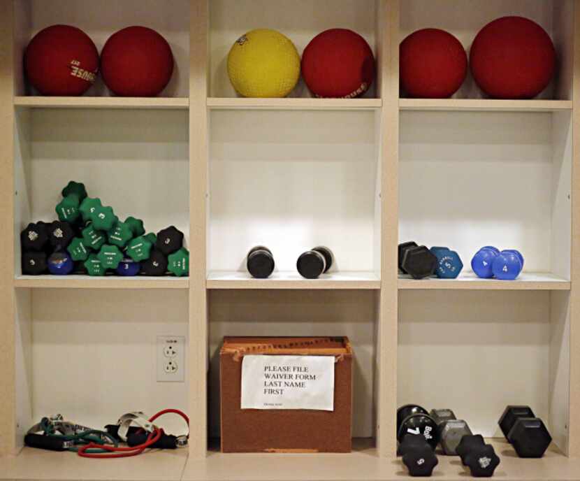 Free weights, medicine balls and other workout equipment sit in wall cubbies at the Edgemere...
