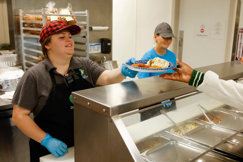 Volunteer and service missionary Sister Danielle Bailey, left, serves lunch as Sandy...