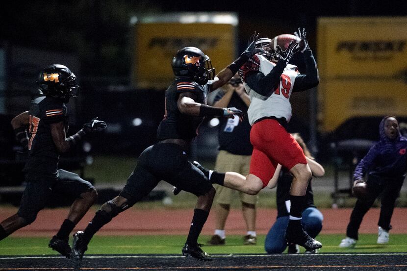 Mansfield Legacy junior wide receiver Nathan Rooney (19) hauls in a touchdown reception in...