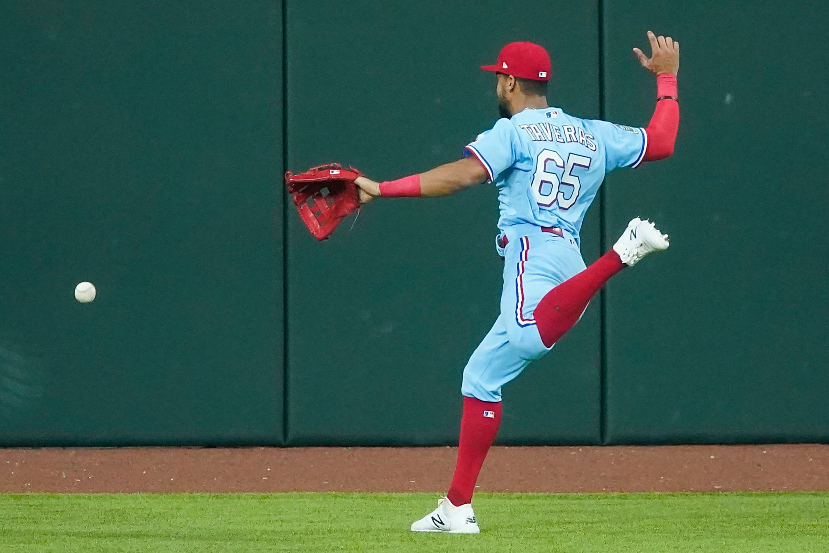 Texas Rangers center fielder Leody Taveras can’t get to a triple off the bat of Oakland...