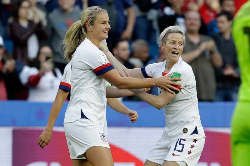 United States' Lindsey Horan, left, is congratulated by teammate Megan Rapinoe, right, after...