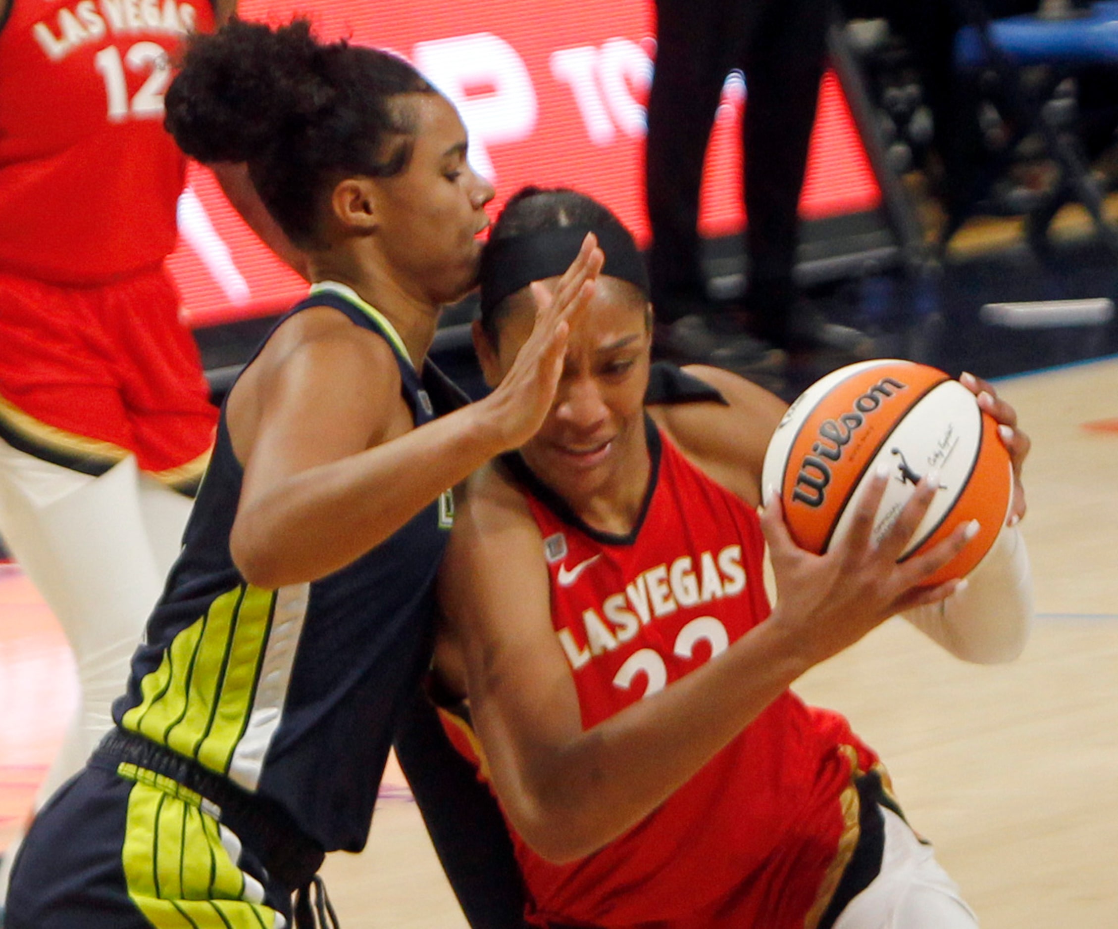 Las Vegas forward A'ja Wilson (22) drives the lane against the defense of Dallas Wings...