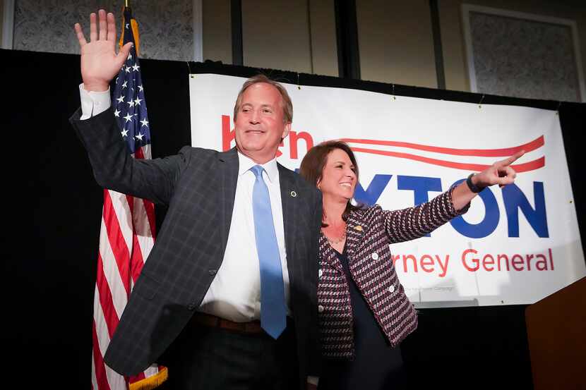 Texas Attorney General Ken Paxton waves to supporters with his wife, State Sen. Angela...