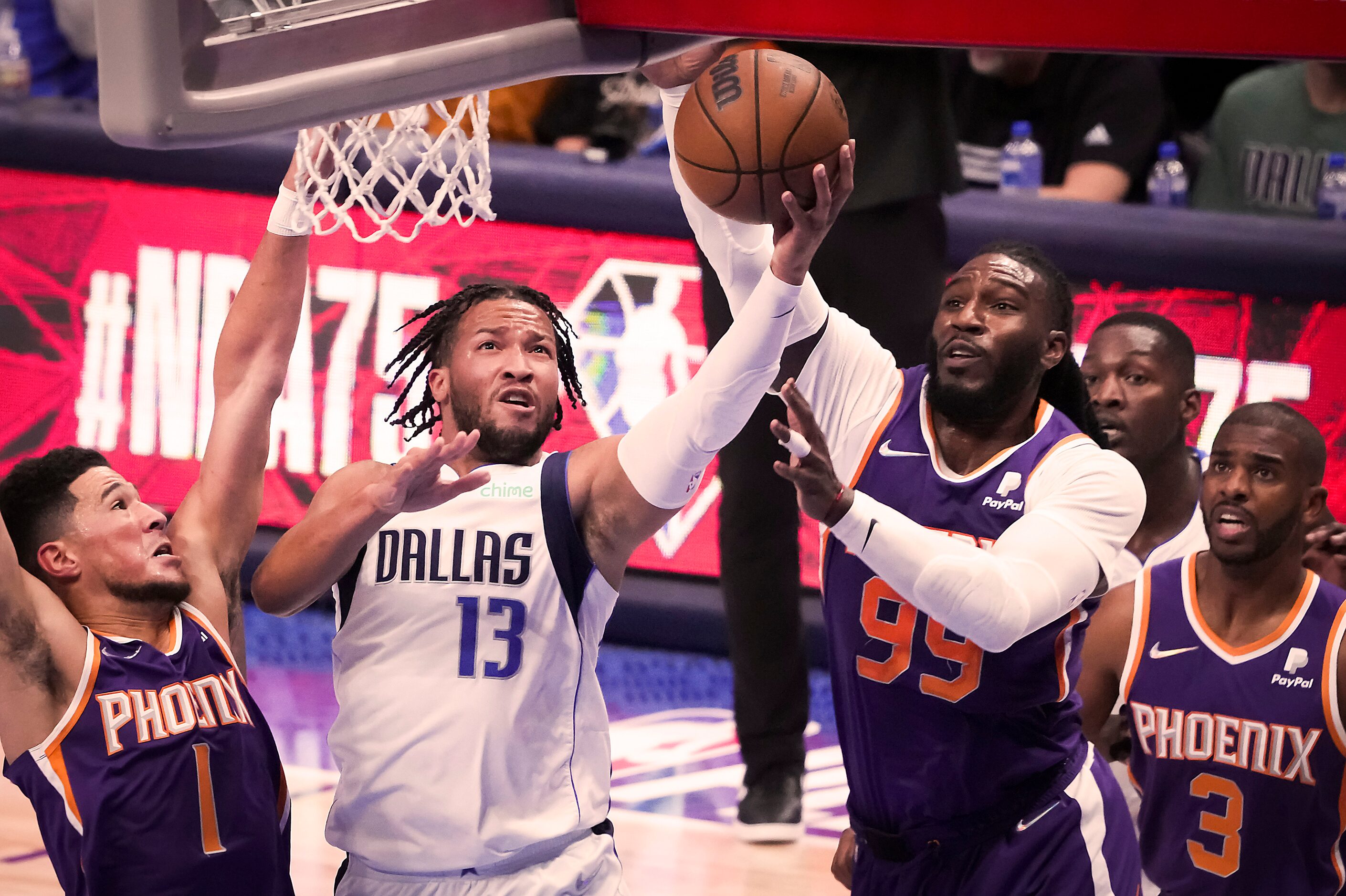 Dallas Mavericks guard Jalen Brunson (13) scores past Phoenix Suns guard Devin Booker (1),...