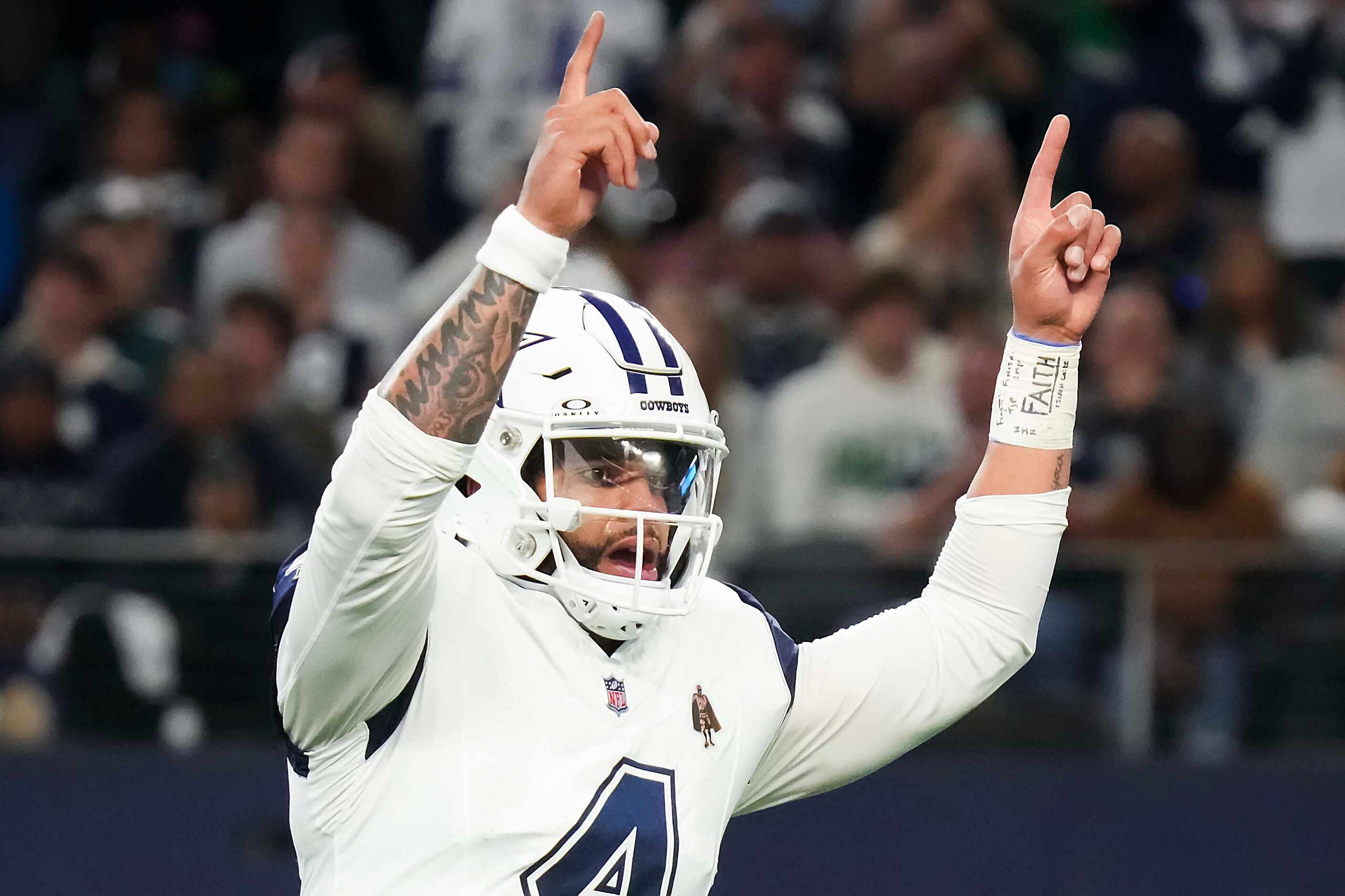 Dallas Cowboys quarterback Dak Prescott celebrates after a 1-yard touchdown run by running...