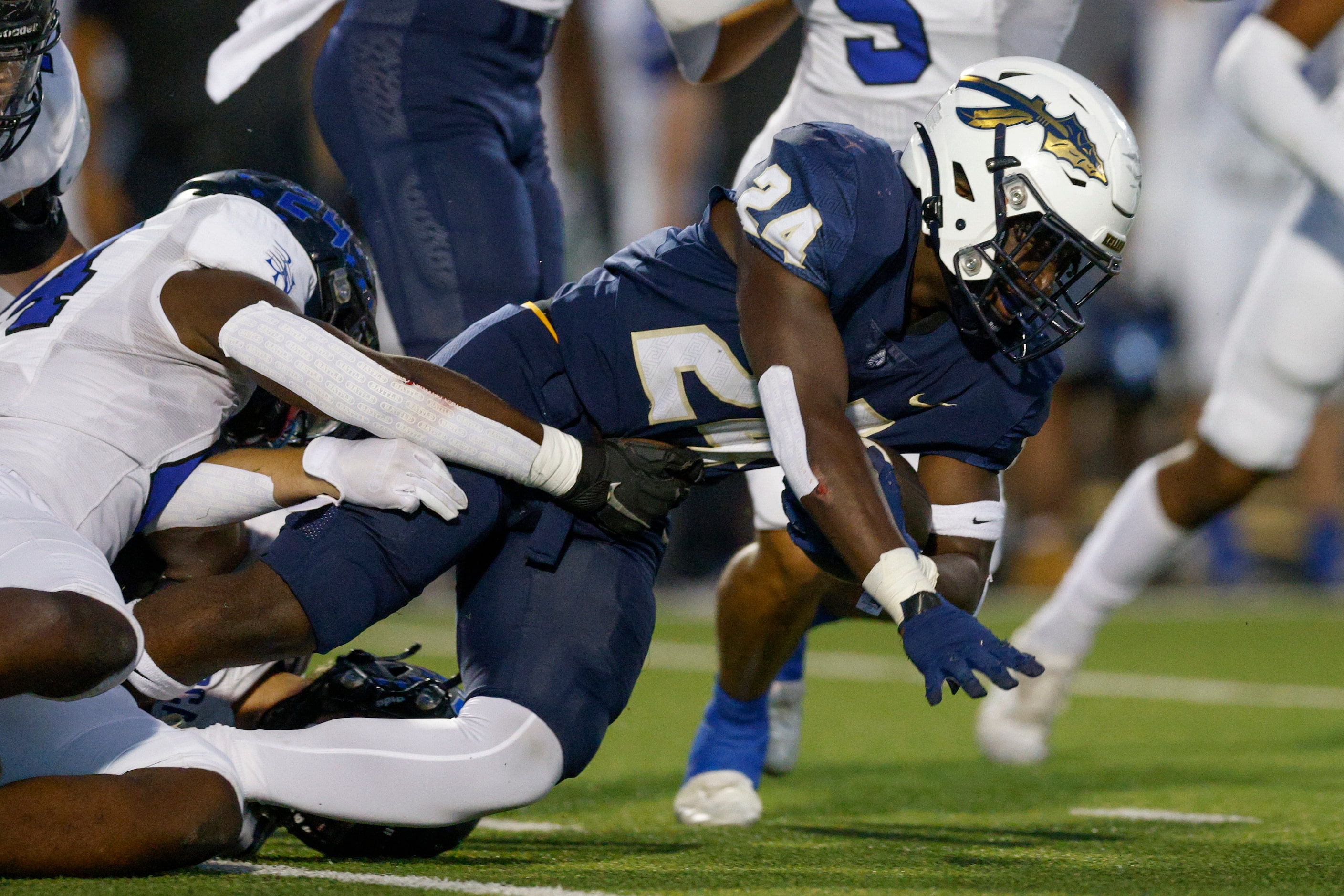 Trophy Club Byron Nelson’s Rubben Tshilombo (24) tackles Keller running back Cameron Rayford...