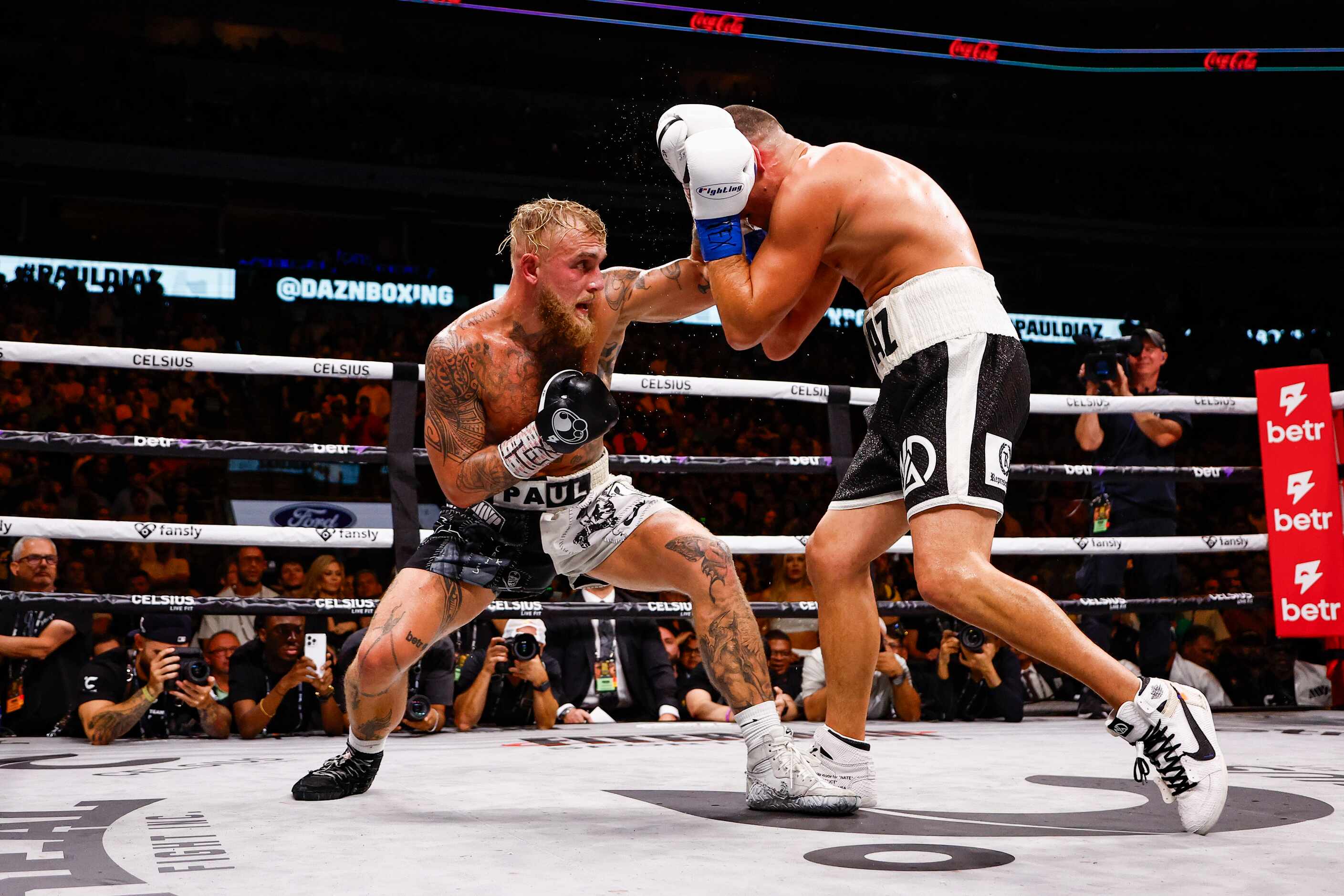 Jake Paul, left, lands a punch on Nate Diaz during a boxing match in Dallas, Saturday,...