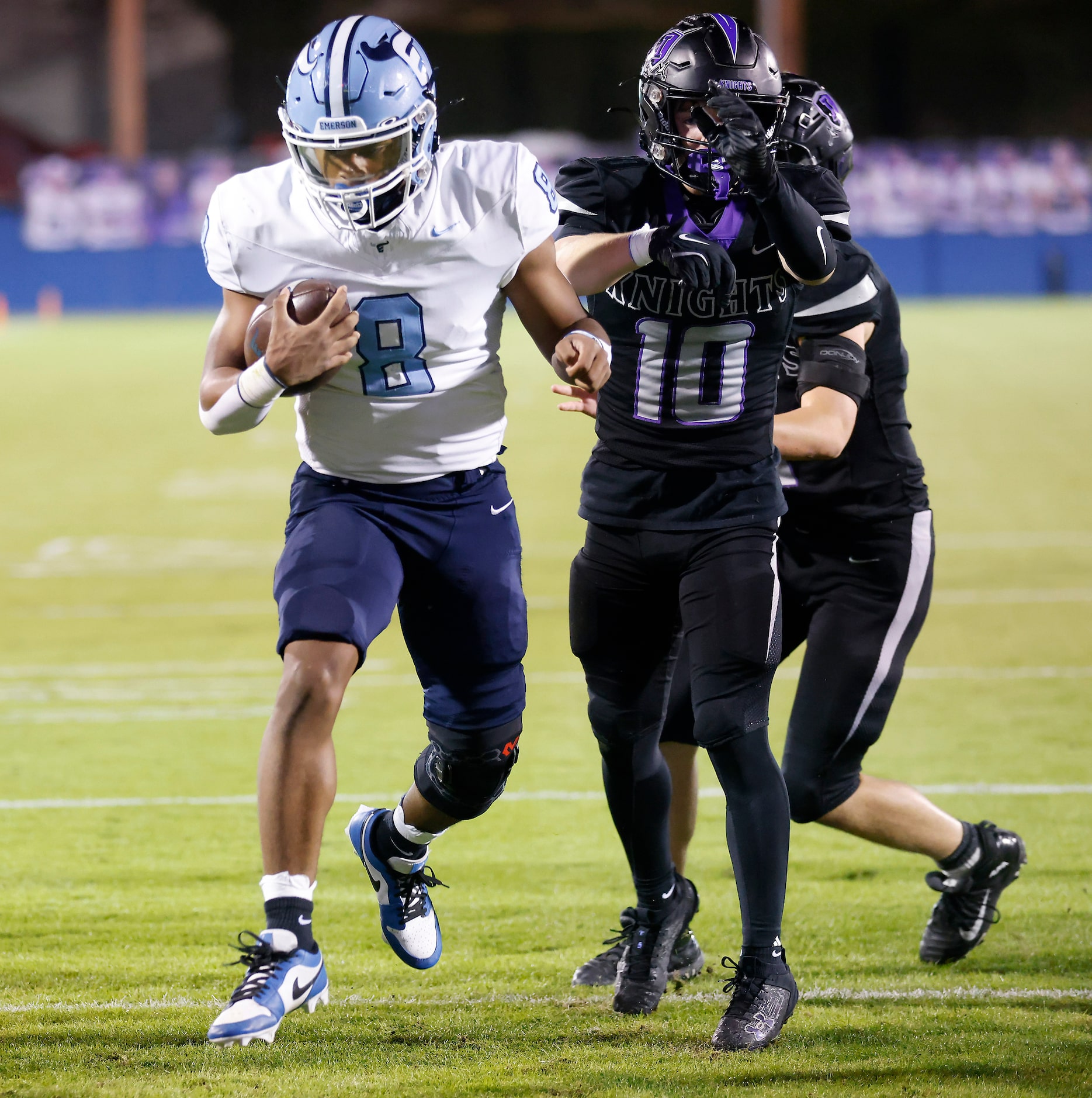 Frisco Emerson running back Kameron Lockhart (8) bounces off a pair of Frisco Independence...