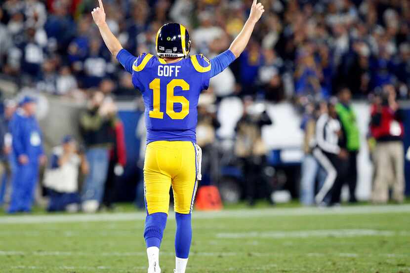 Los Angeles Rams quarterback Jared Goff (16) throws up his arms as running back Todd Gurley...