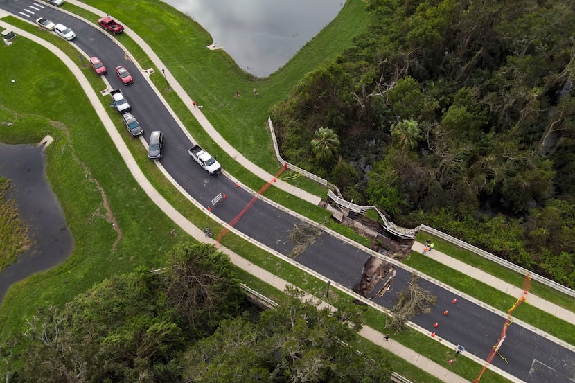 A sink hole is visible on a road damaged by Hurricane Milton, Friday, Oct. 11, 2024, in...