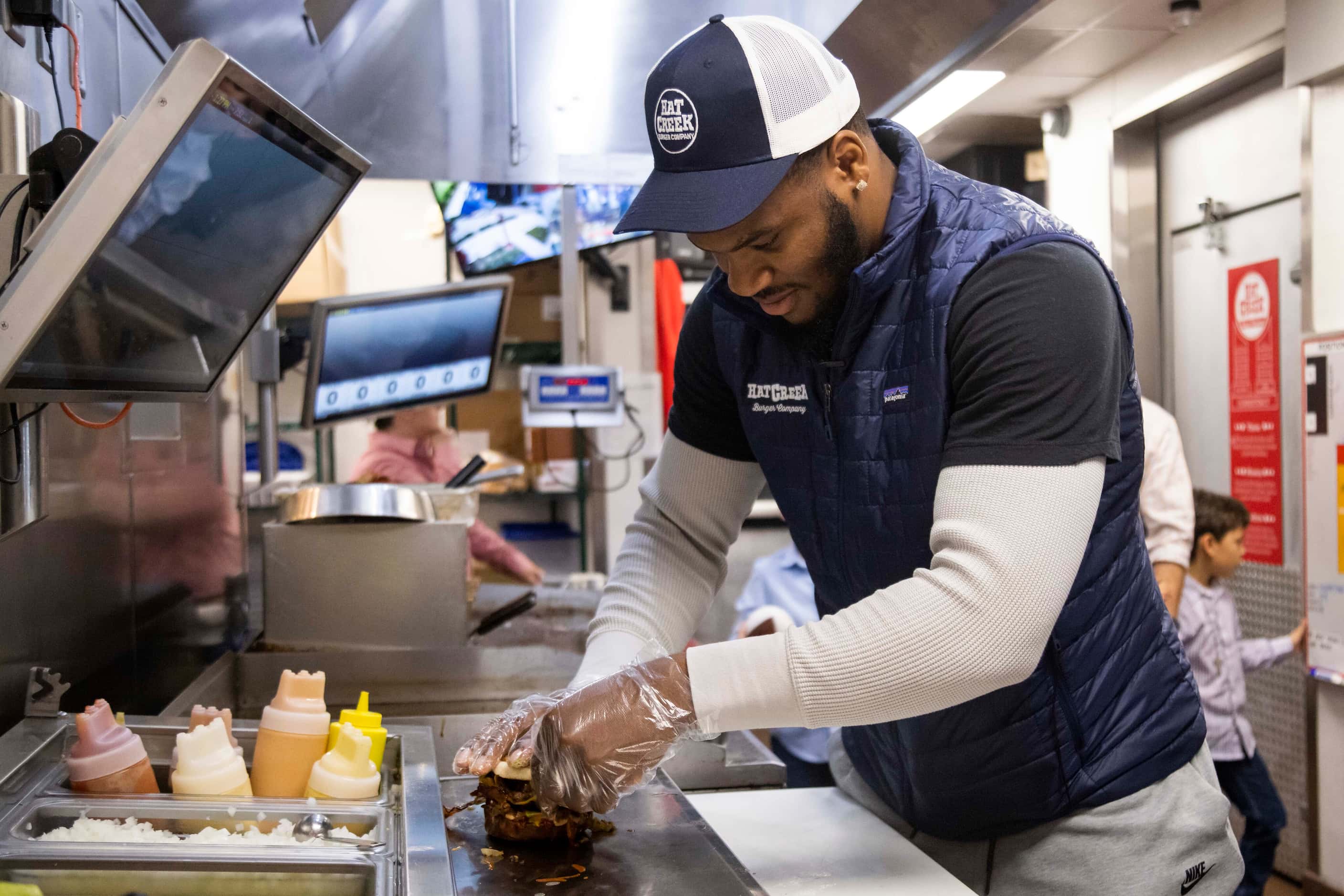 Dallas Cowboys linebacker Micah Parsons places the top bun on his custom “Micah” burger at...