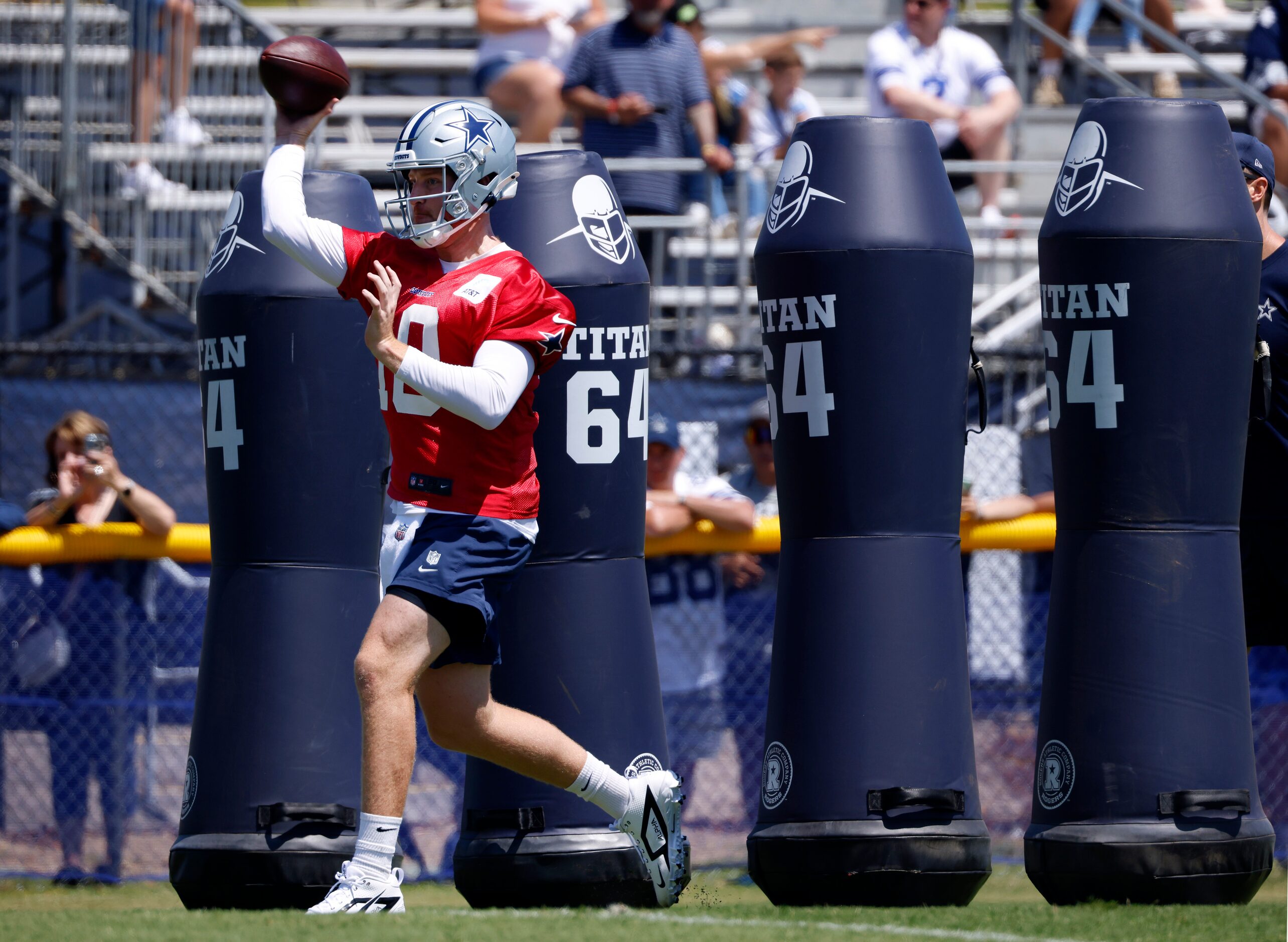 Dallas Cowboys quarterback Cooper Rush (10) maneuvers through the tackling dummies before...