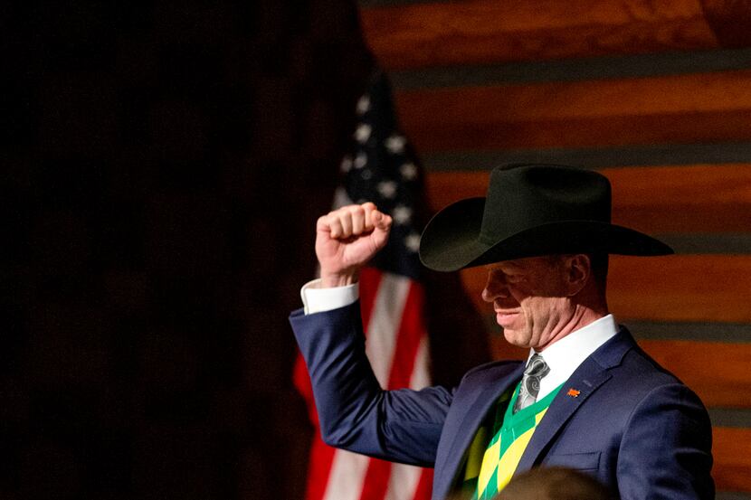 John Keating, Deputy Mayor Pro Tem, raises his fist during a Frisco City Council meeting at...