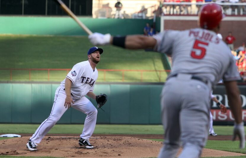 Texas starting pitcher Ryan Dempster watches as Angels slugger Albert Pujols hits a...