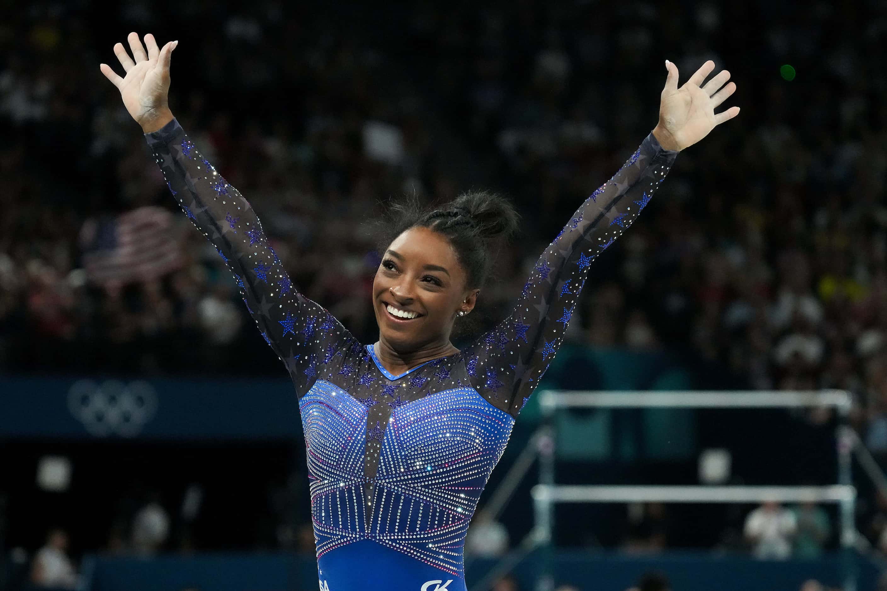 Simone Biles of the United States celebrates after competing on the balance beam during the...