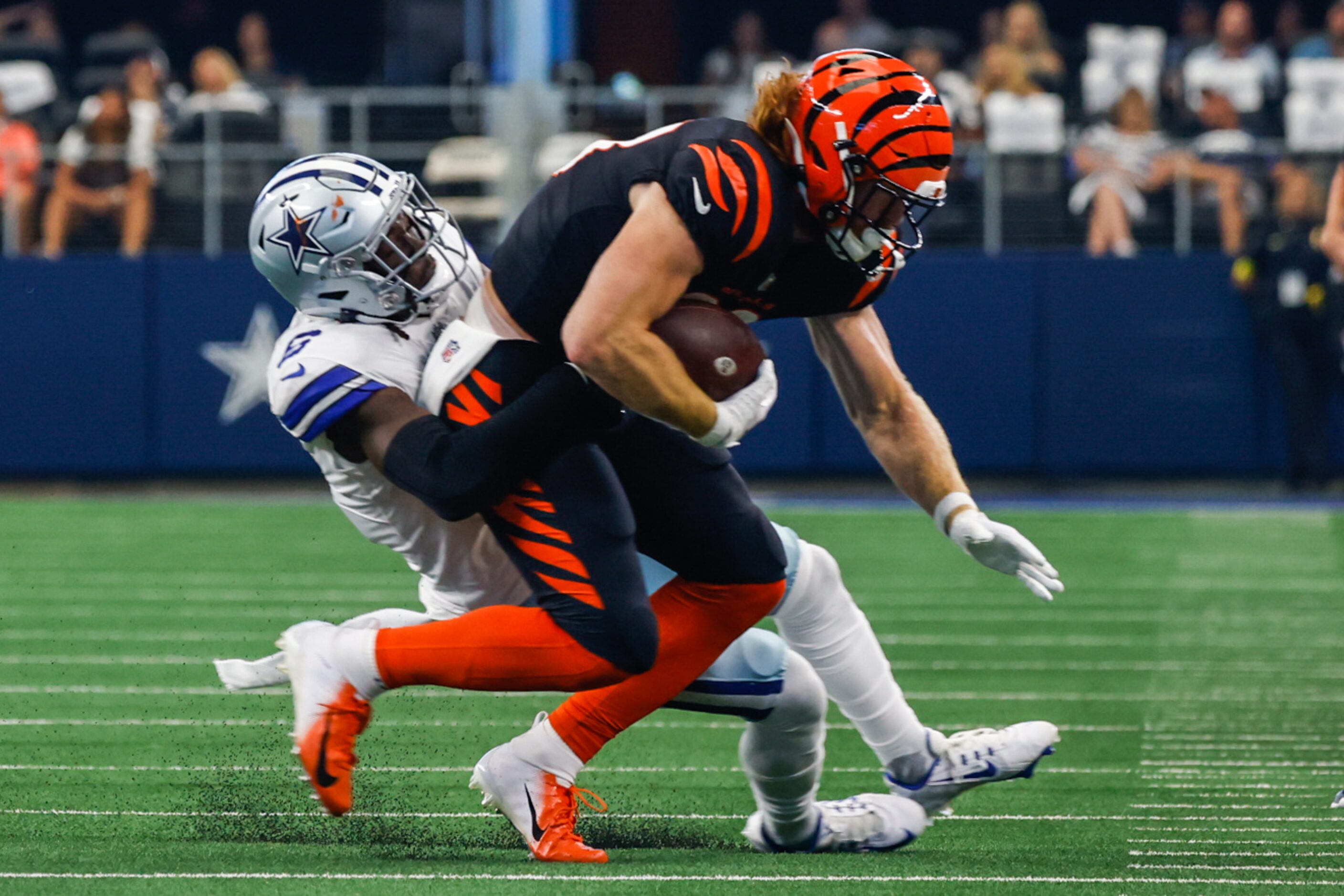 Cincinnati Bengals tight end Hayden Hurst (88) gets tackled by Dallas Cowboys safety Donovan...