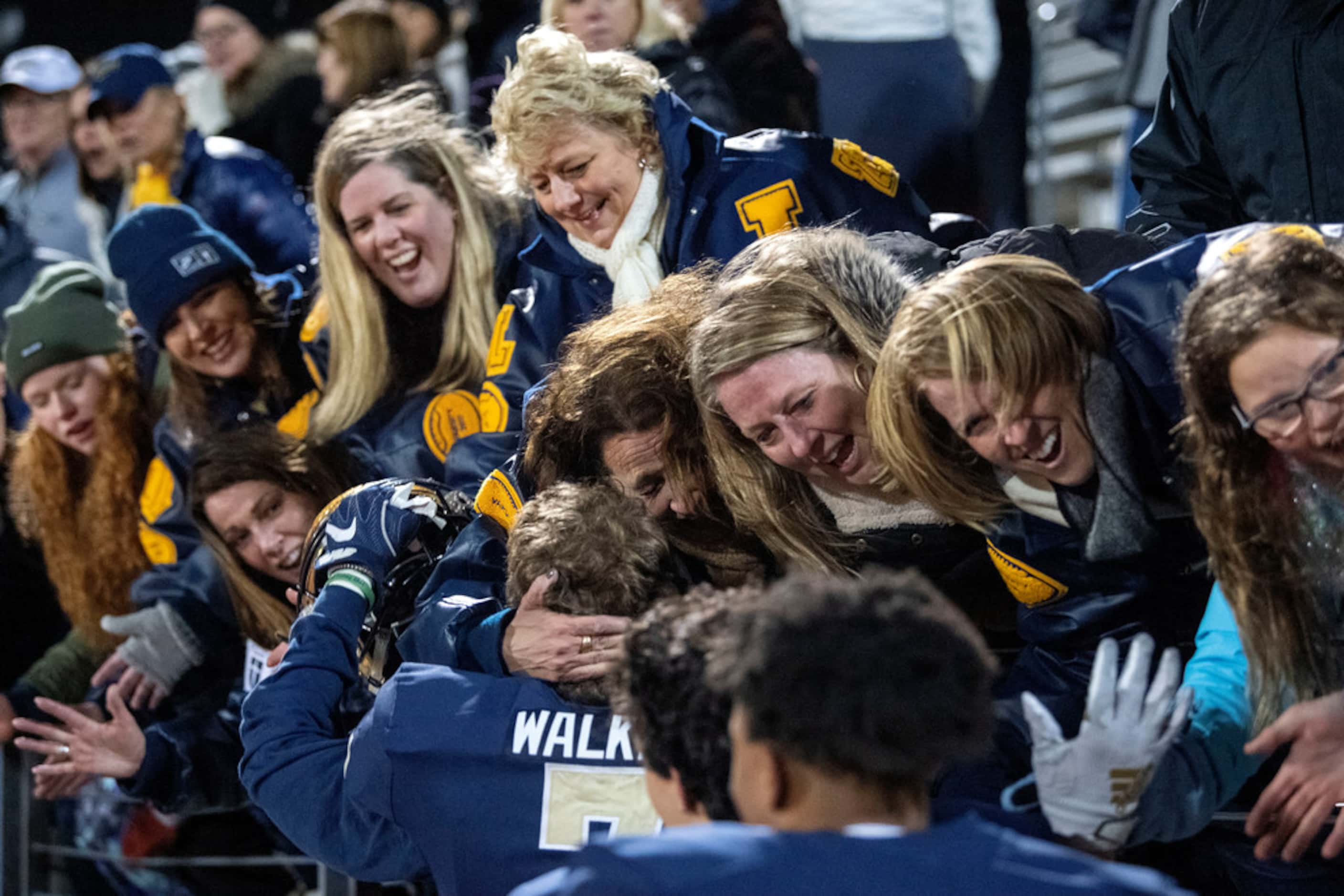 Jesuit football moms celebrate with their sons after their 27-25 upset win over defending...