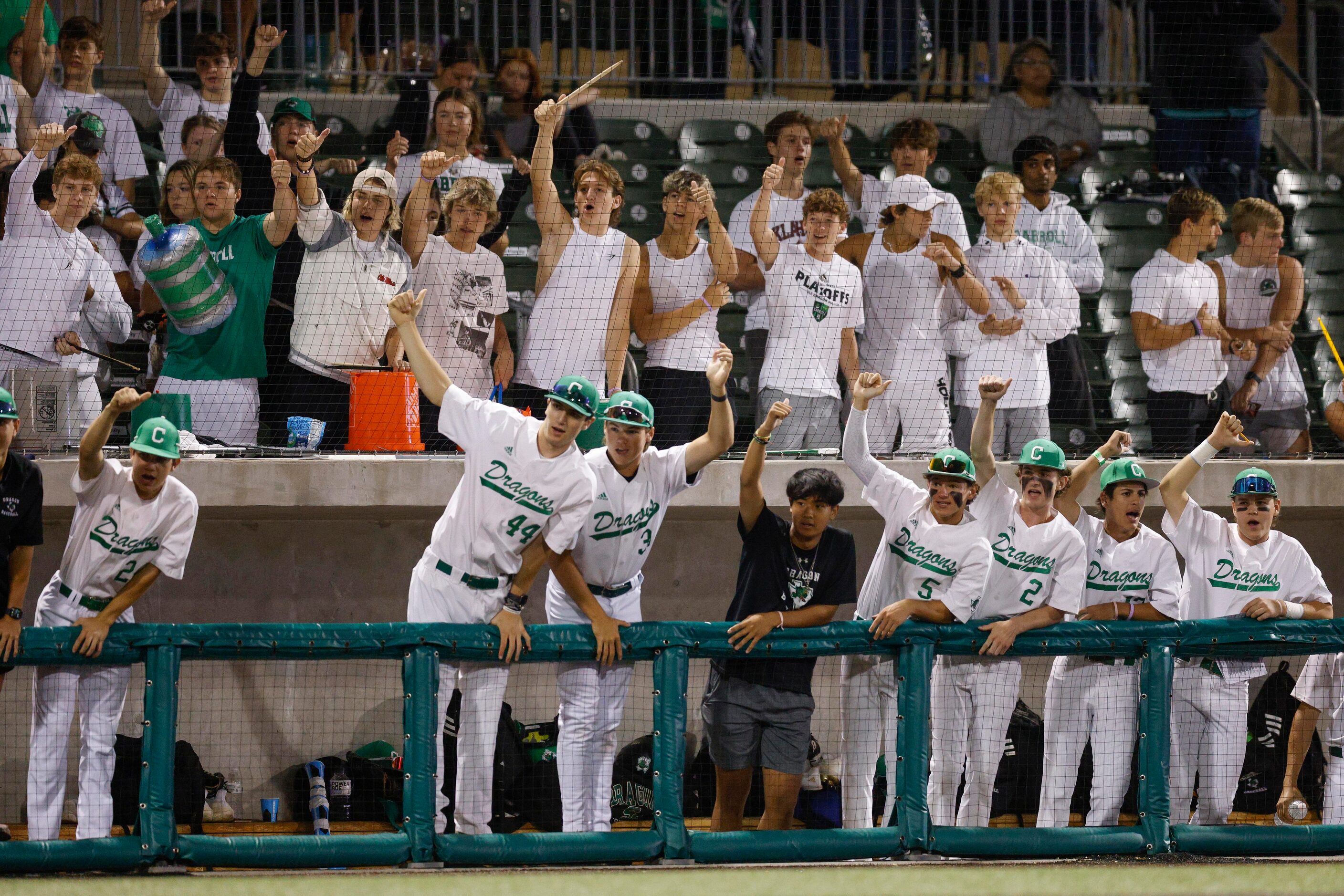 Southlake Carroll players and fans celebrate a strikeout by starting pitcher Griffin Herring...