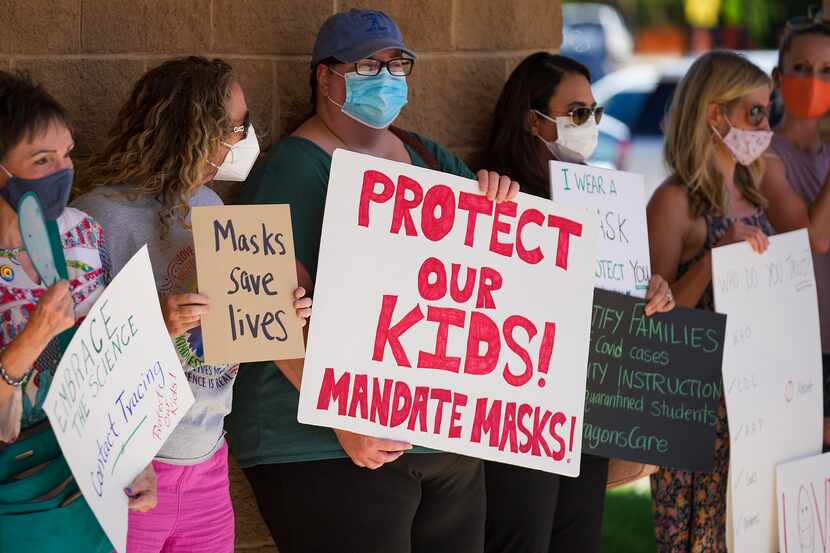 Supporters of mask mandates lined up before Monday's Carroll ISD school board meeting in...