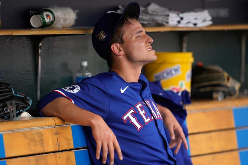 Texas Rangers pitcher Jack Leiter watches from the dugout after being pulled against the...