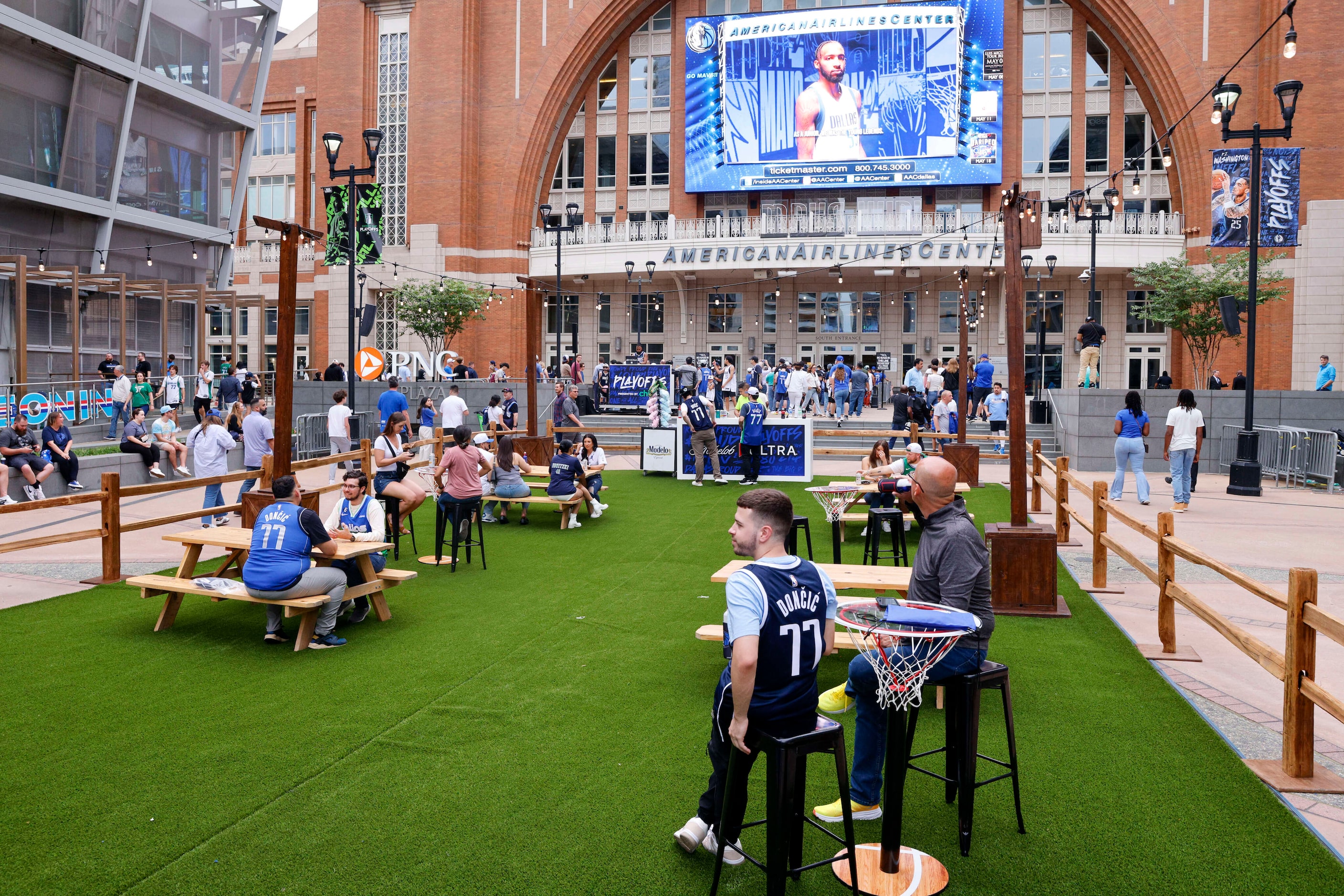 Fans sit outside American Airlines Center before Game 6 of an NBA basketball first-round...