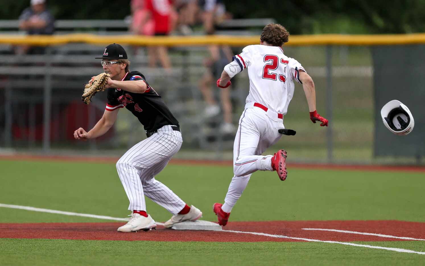 Justin Northwest outfielder Shannon Danicki (23) is called out at first basse as Mansfield...