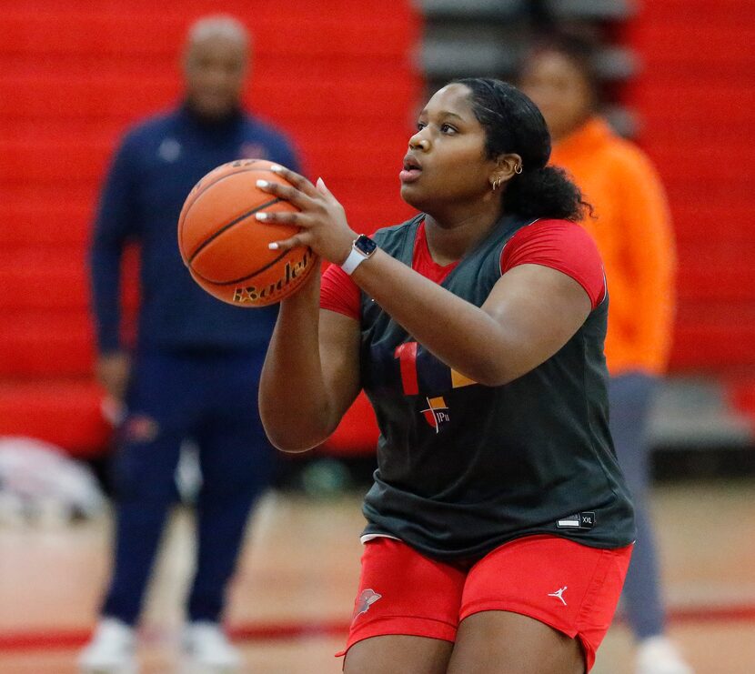 Taylor Haggan, forward for John Paul II High School in Plano, shoots at practice on...