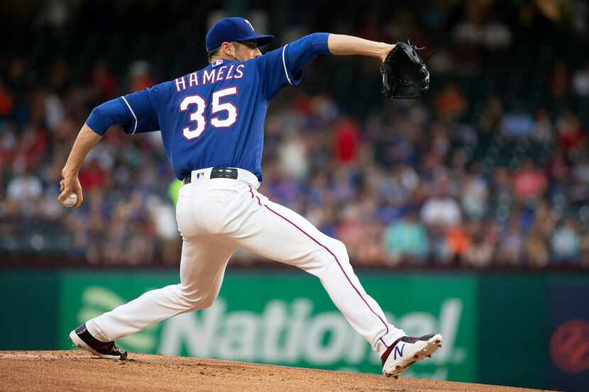 Texas Rangers starting pitcher Cole Hamels delivers a pitch during the first inning against...