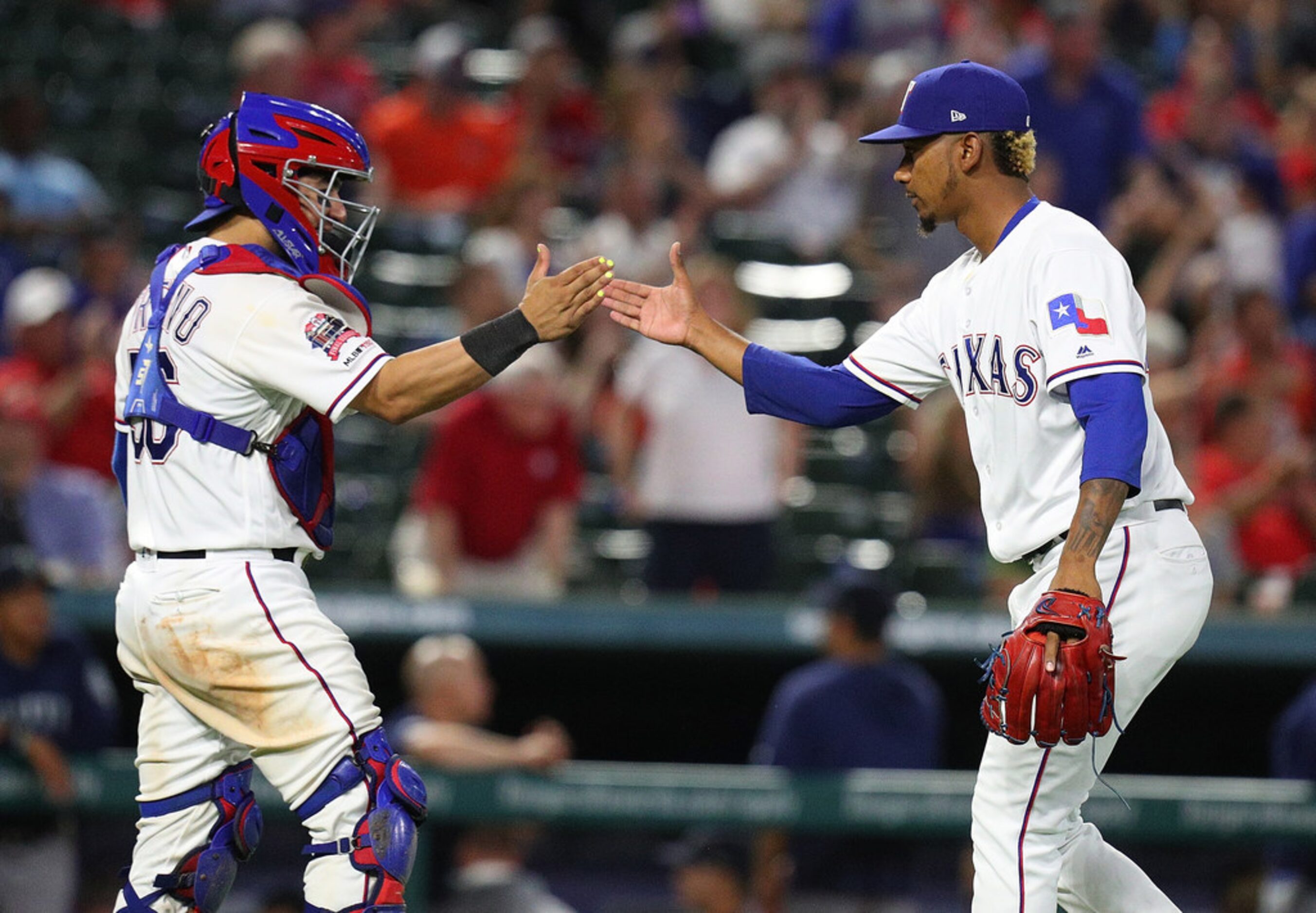 ARLINGTON, TEXAS - AUGUST 30: Jose Trevino #56 and Emmanuel Clase #43 of the Texas Rangers...