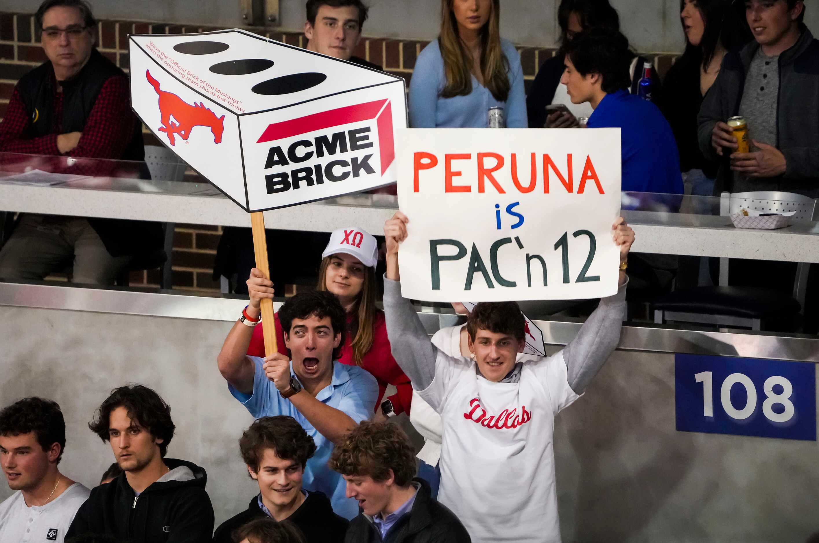 A fan holds a sign referencing rumors connecting SMU with Pac-12 conference expansion during...