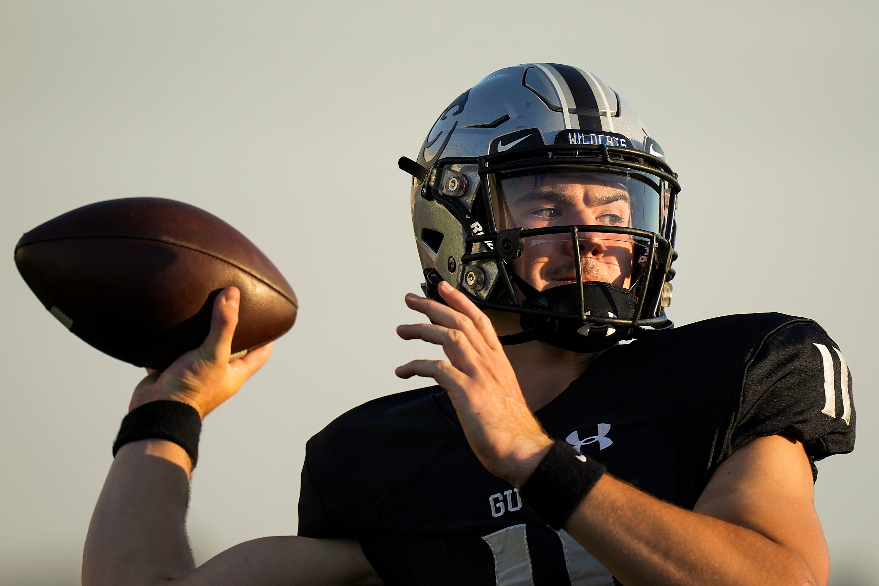 Denton Guyer quarterback Jackson Arnold (11) warms up before a high school football game...