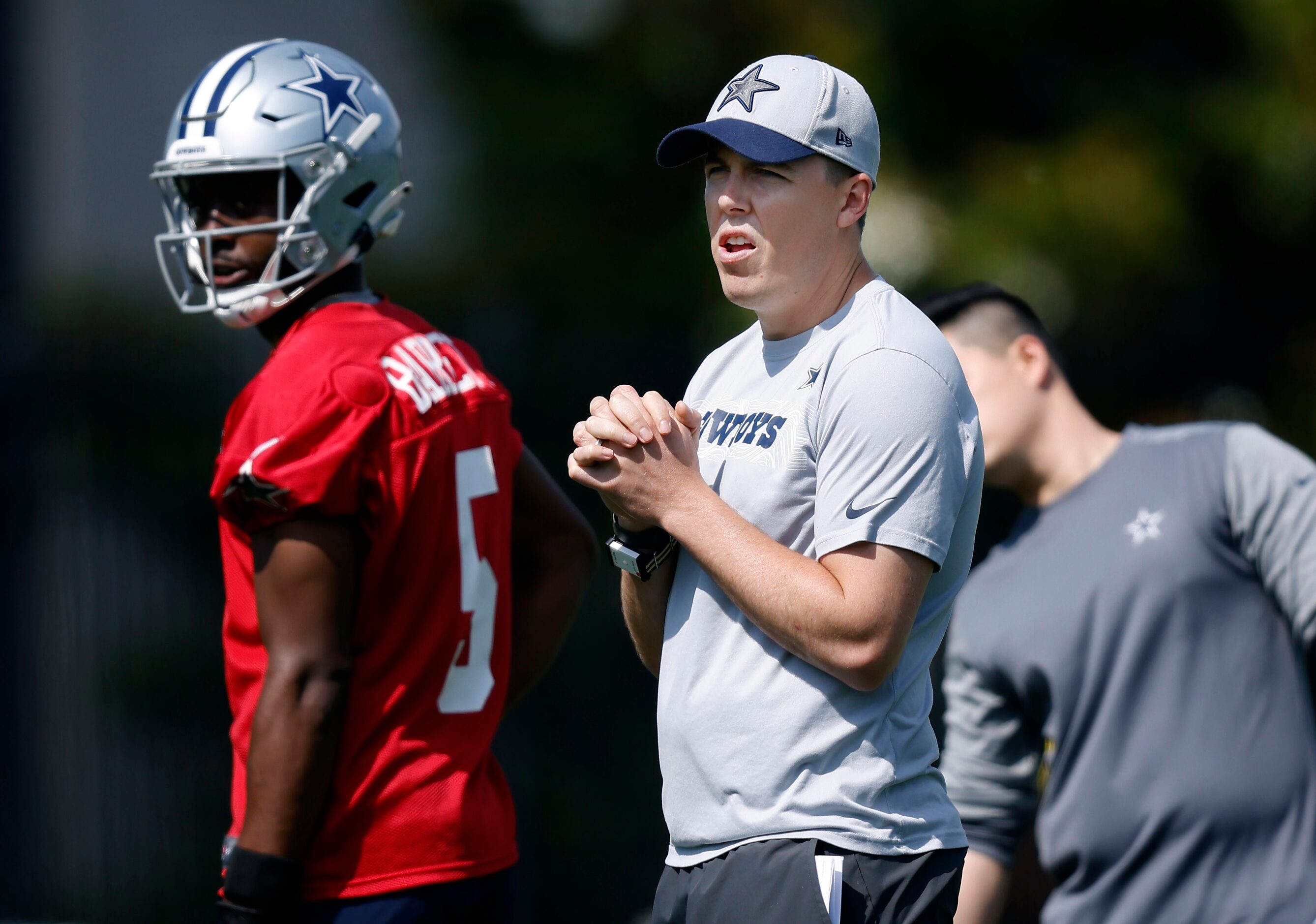 Dallas Cowboys offensive coordinator Kelln Moore works with quarterback JT Barrett (5)...