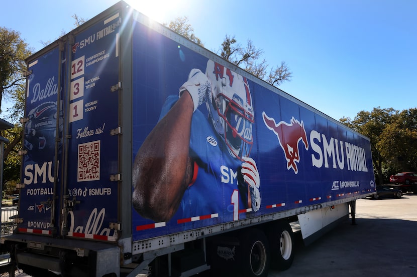 Members of the SMU Mustangs equipment crew loaded team necessities into the team's tractor...