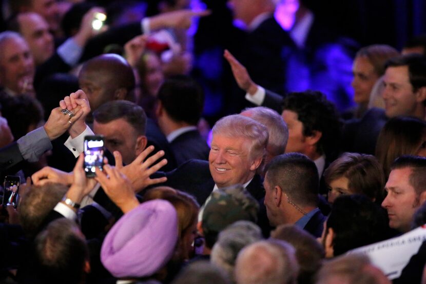 President-elect Donald Trump shakes hands with supporters after making his acceptance speech...