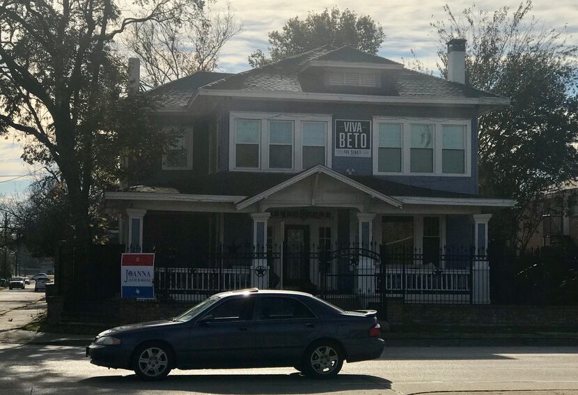 Two signs — one for Joanna Cattanach and another for Beto O'Rourke — are displayed in front...