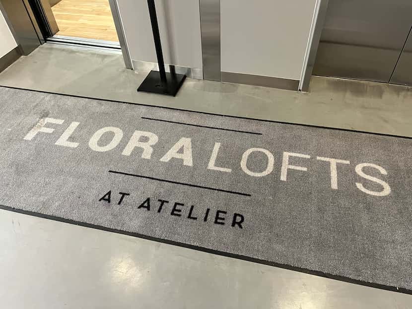 A doormat inside Atelier bears the Flora Lofts name. Its one in a handful of reminders that...