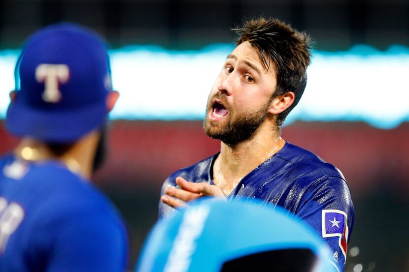 Texas Rangers left fielder Joey Gallo (right) warns Rougned Odor not to dump him with a...