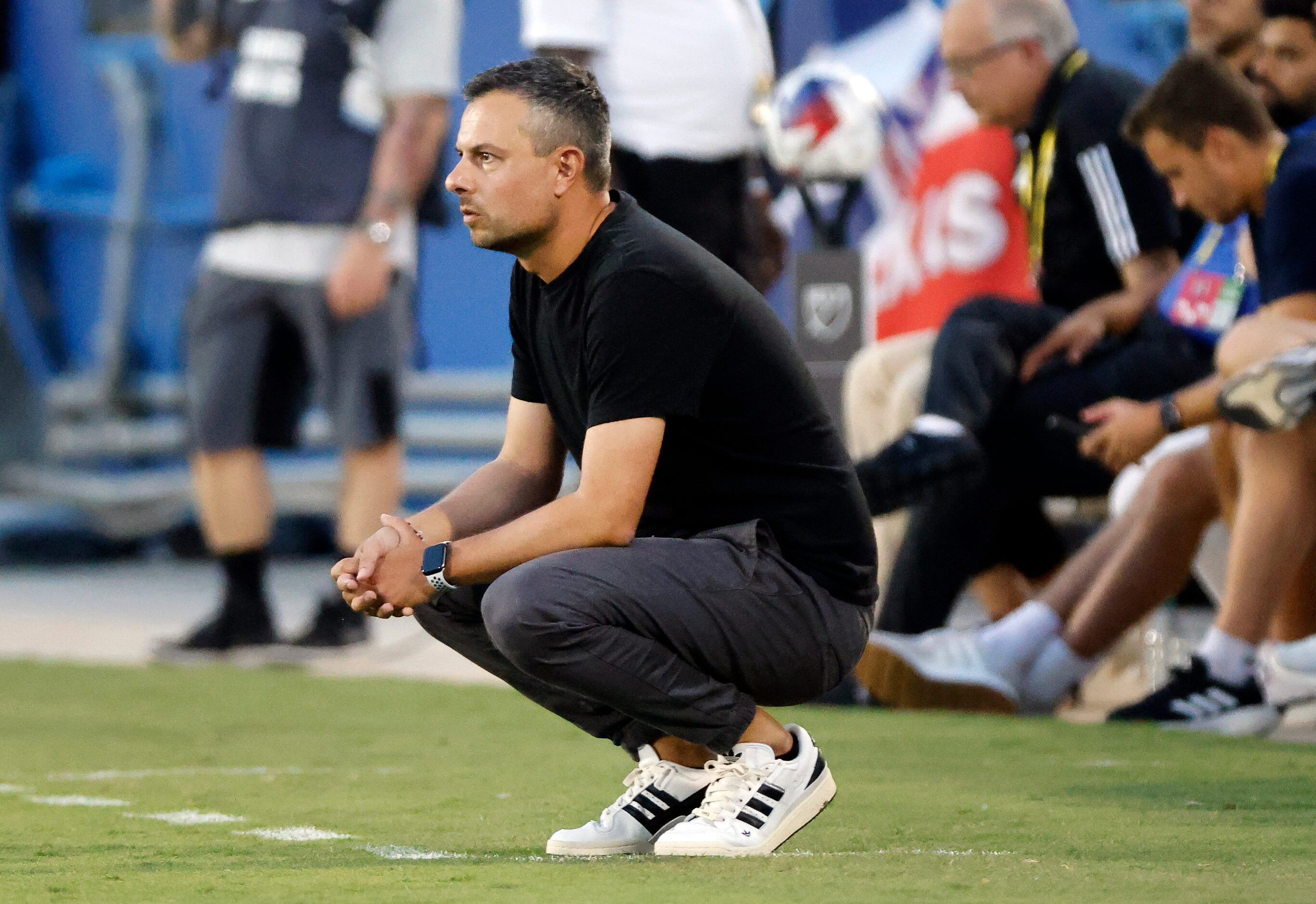 FC Dallas head coach Nico Estévez watches as his team faces Charlotte FC during the first...