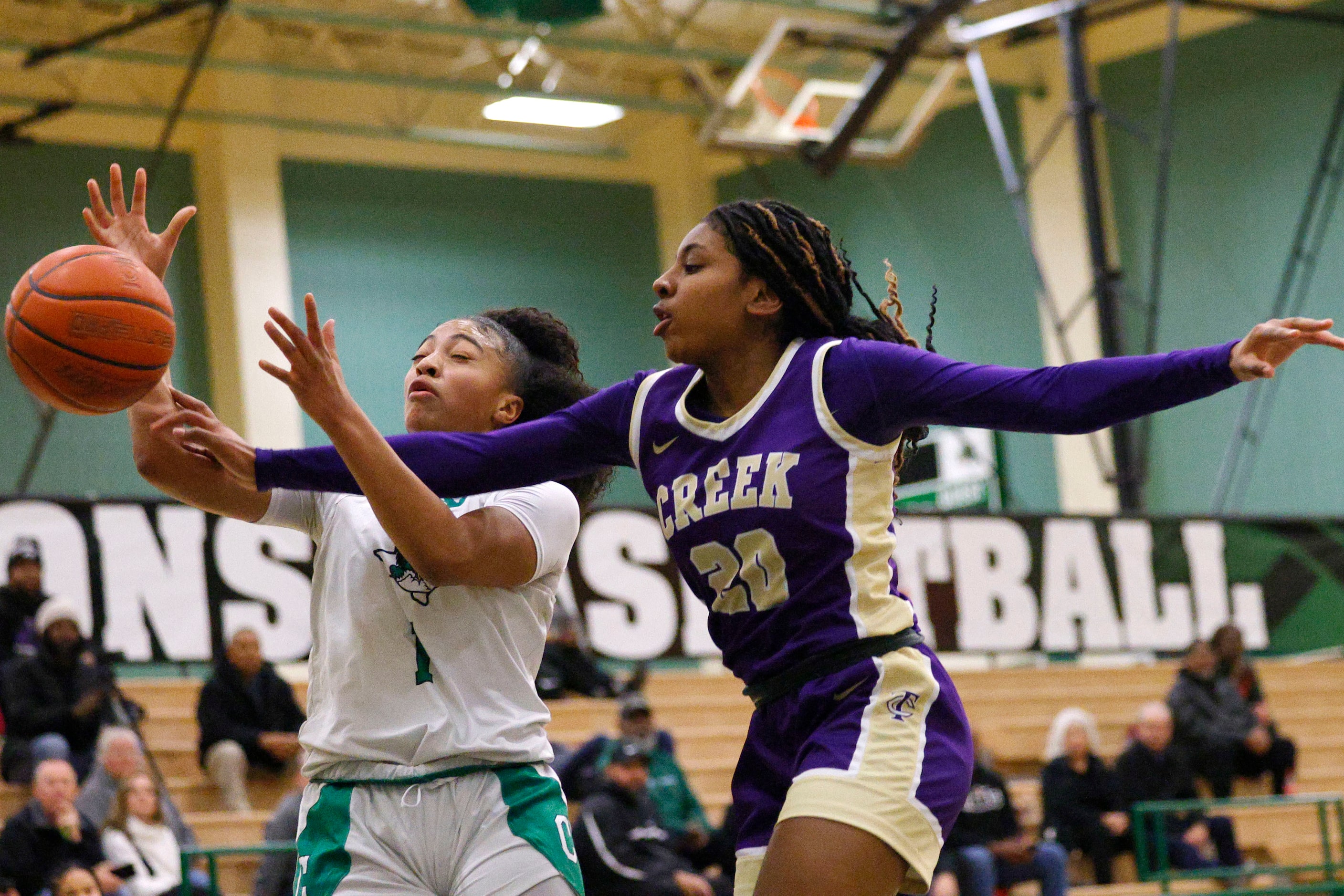 Keller Timber Creek's Selah Armstrachan (20) defends as Southlake Carroll's Milania Jordan...