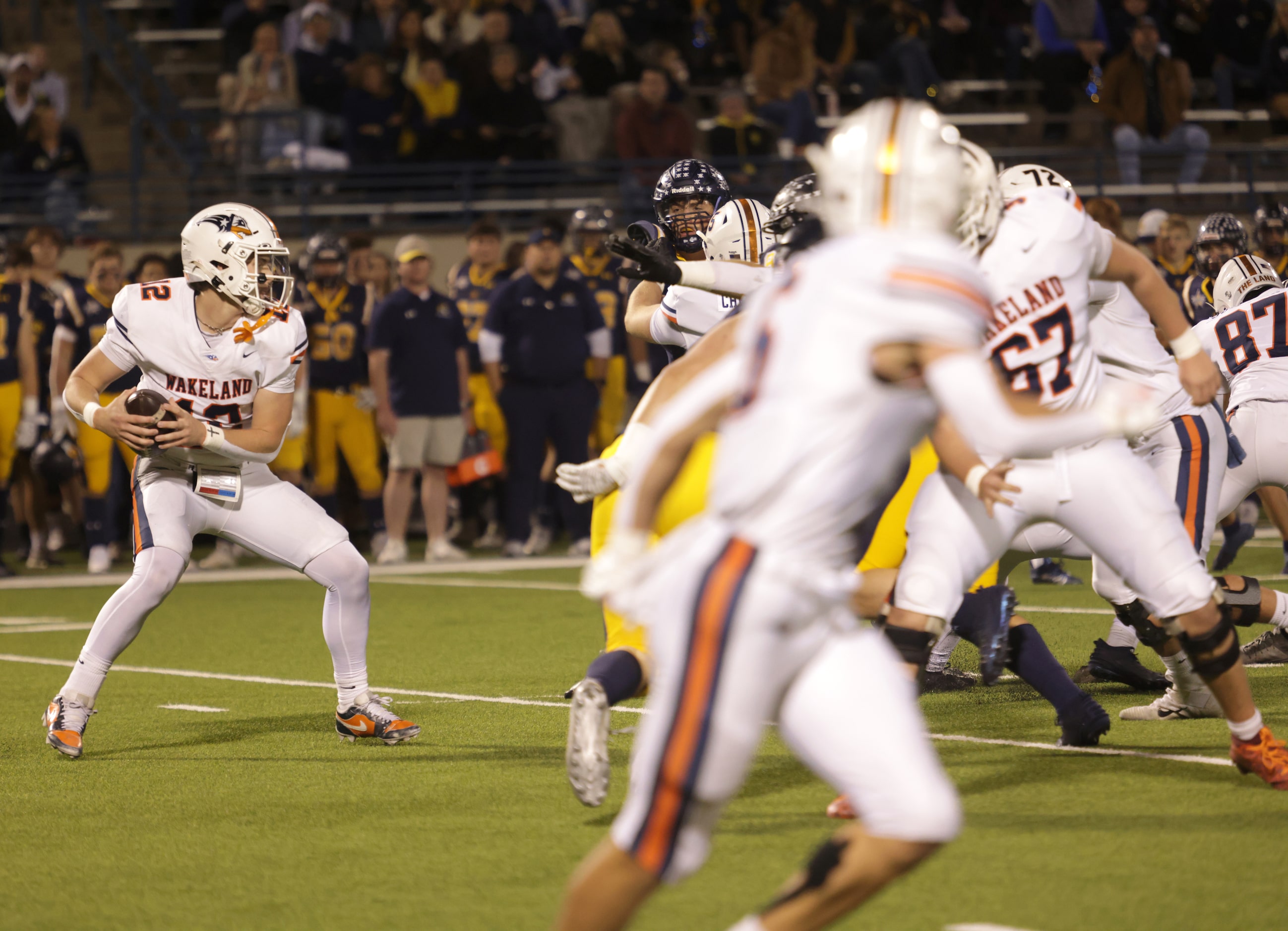 Frisco Wakeland quarterback Jayden Maples receives a snap in a high school football playoff...