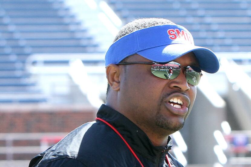 Claude Mathis, new running backs coach for the SMU Mustangs football team, directs his...