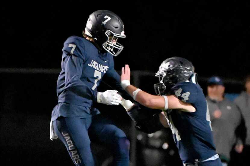 Flower Mound's Cade Harwell (7) and Flower Mound's Ryan Brubaker (44) celebrate after a...