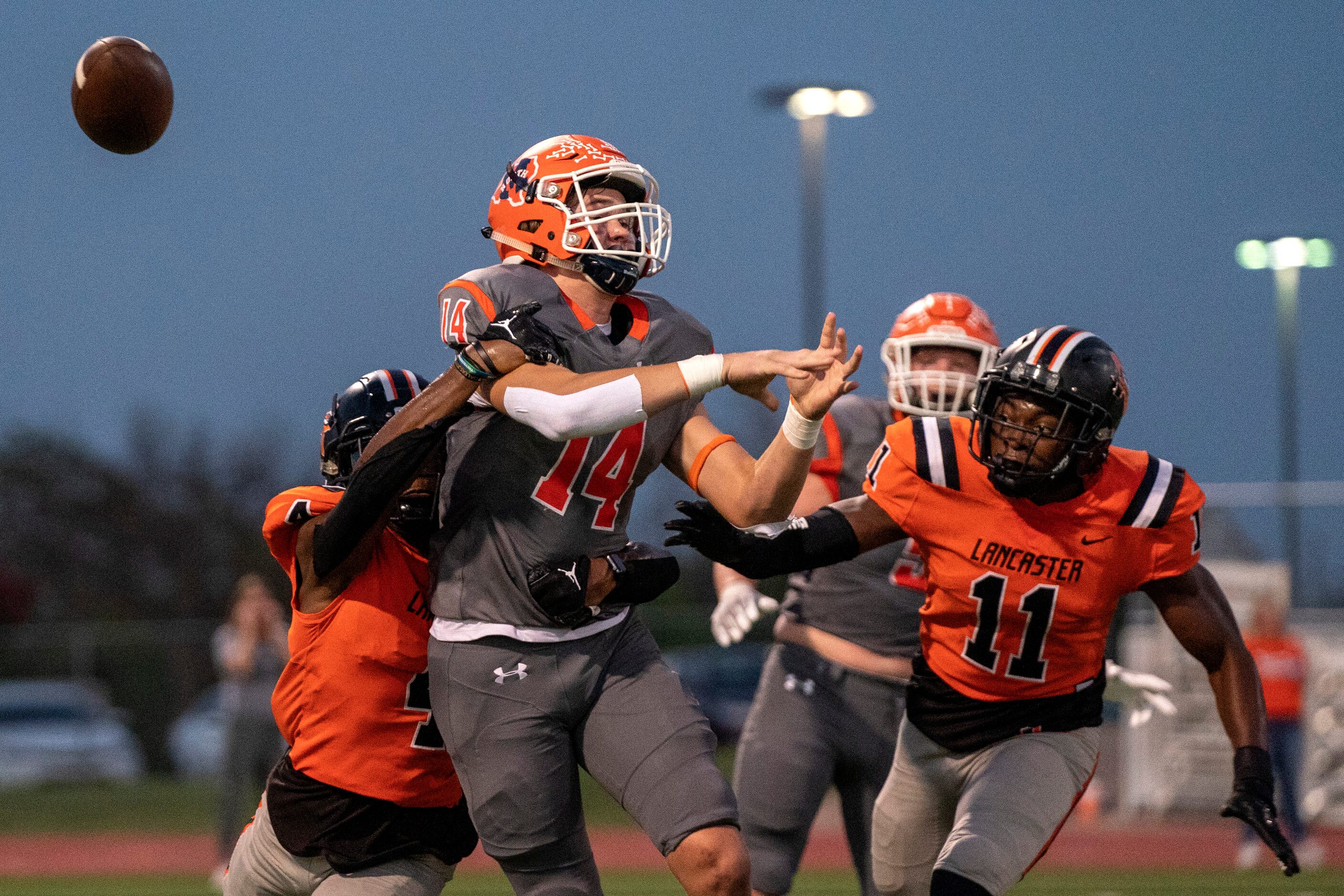 Lancaster senior defensive back Dwight Jones (4) causes McKinney North junior quarterback...