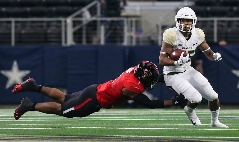 Texas Tech Red Raiders linebacker Jordyn Brooks (1) attempts to bring down Baylor Bears...