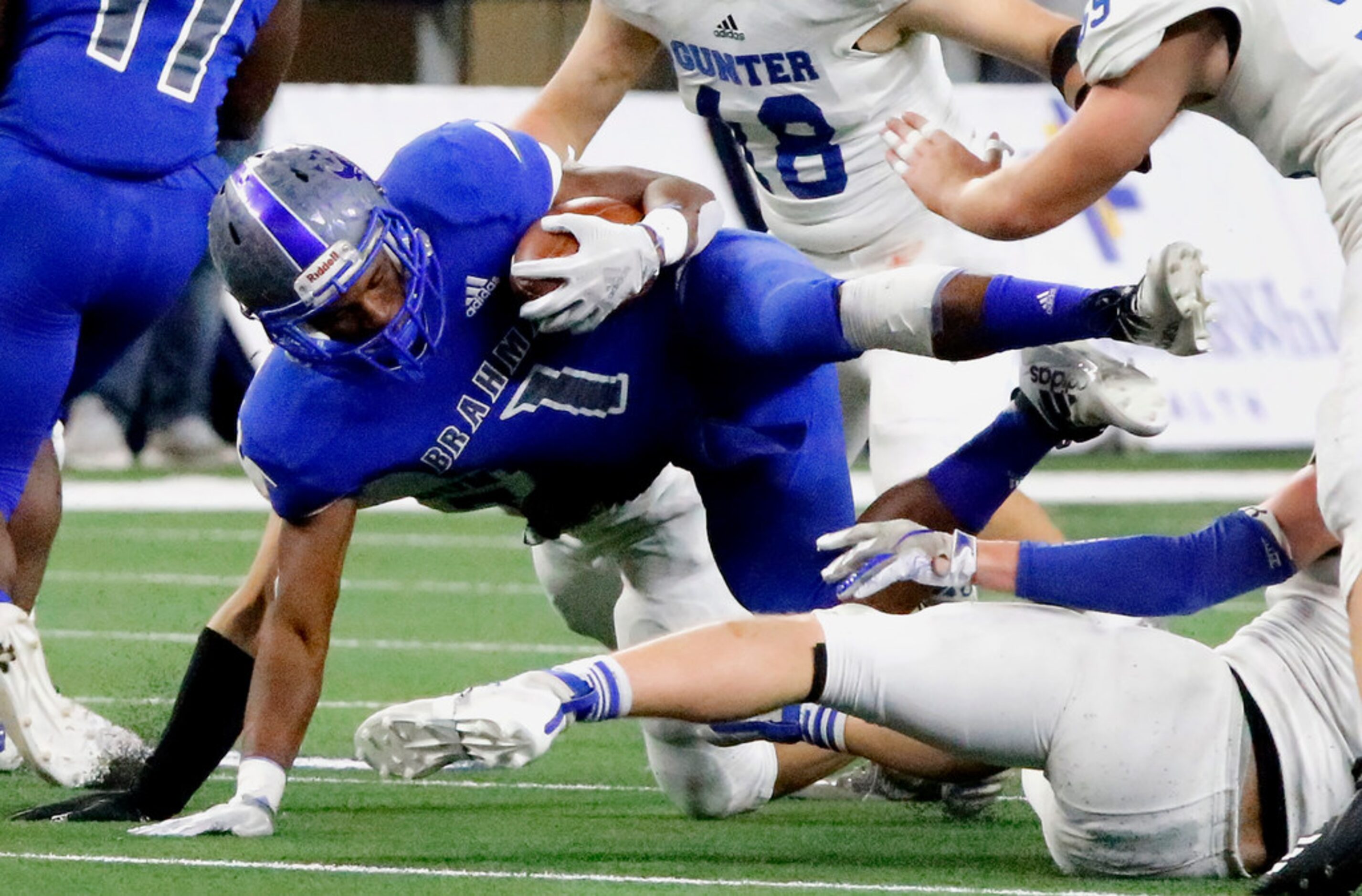 Omaha Pewitt High School running back Kadrien Johnson (1) is knocked off of his feet during...