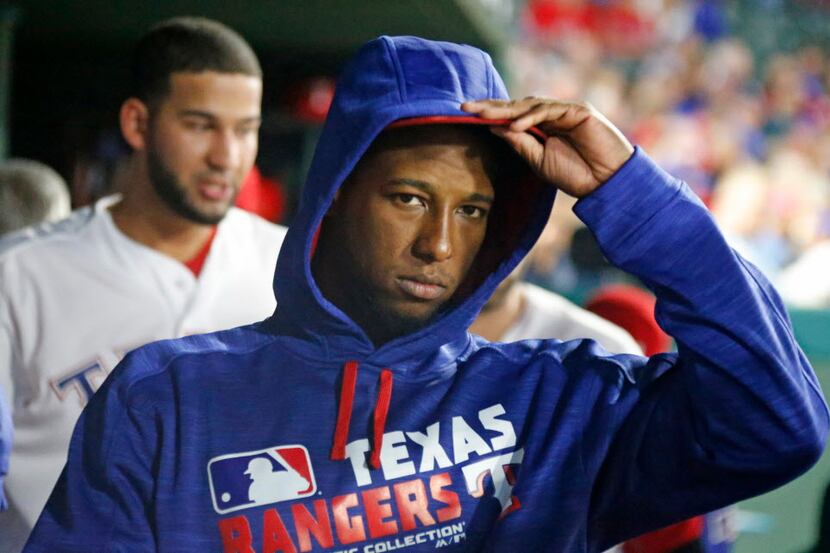 Texas Rangers third baseman Jurickson Profar (19) dons a sweatshirt as the temperature drops...