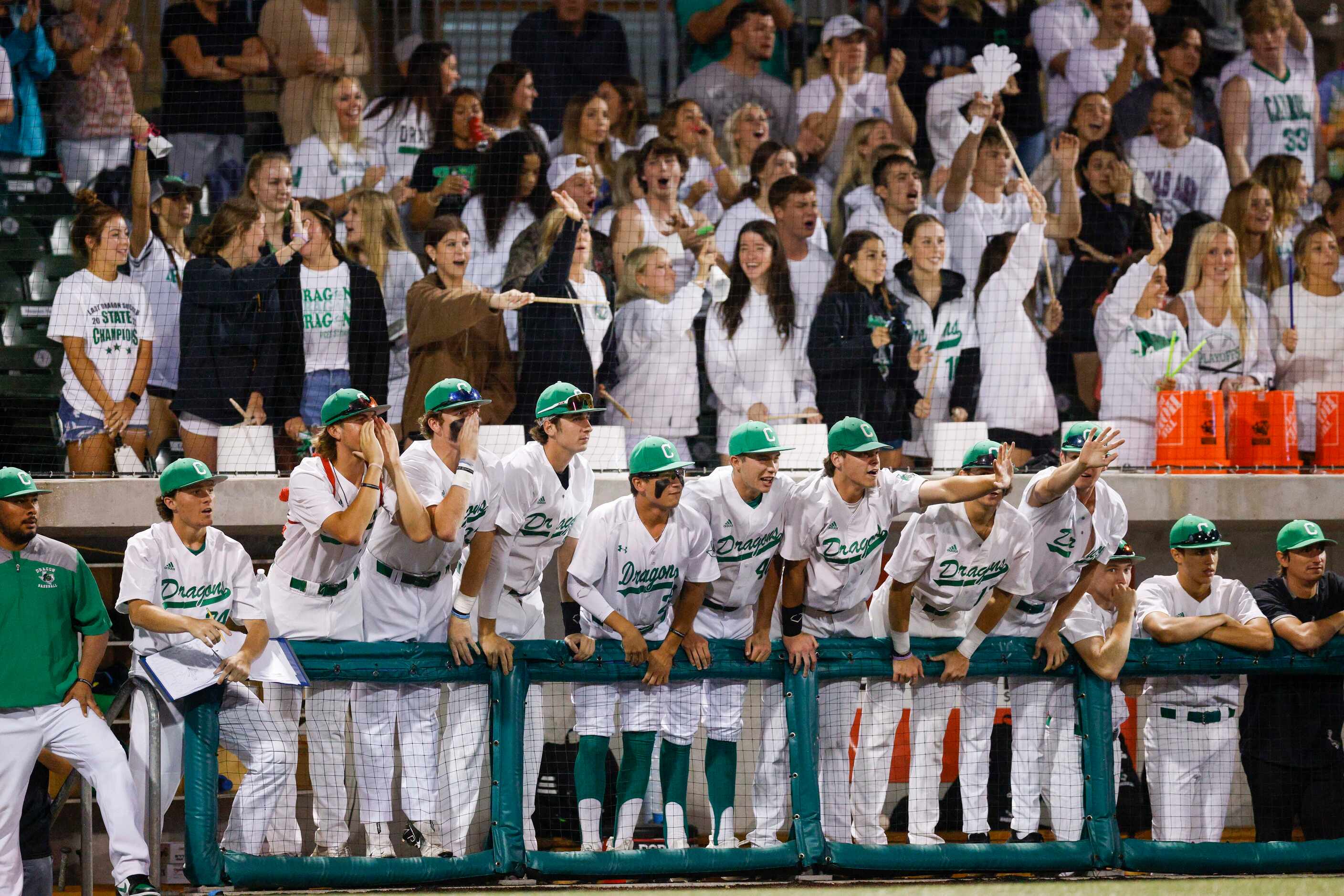 The Southlake Carroll bench and fans cheer during the second inning of a game against Keller...